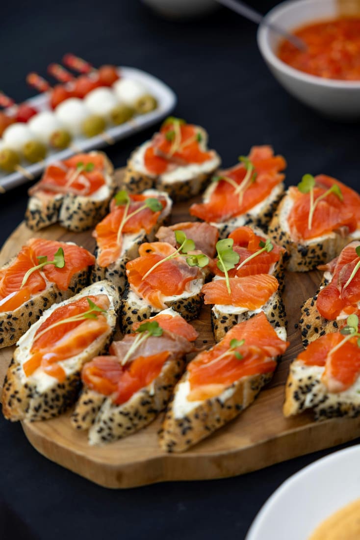 Salmon canapés on a wooden board